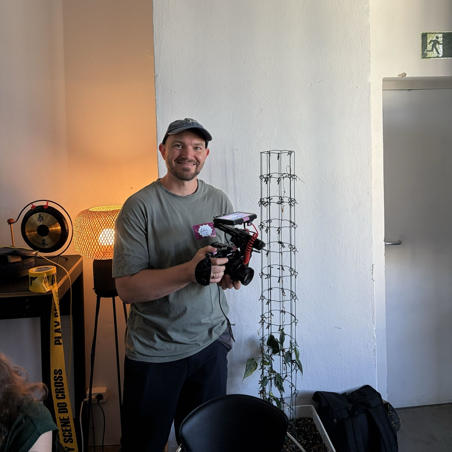Lukas Rieder smiling while holding a caged camera rig at Serious Games for Serious Change in Berlin.