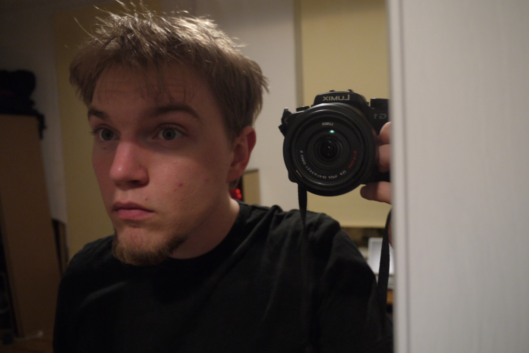 A young Lukas Rieder taking a mirror selfie while holding his first Panasonic Lumix camera.